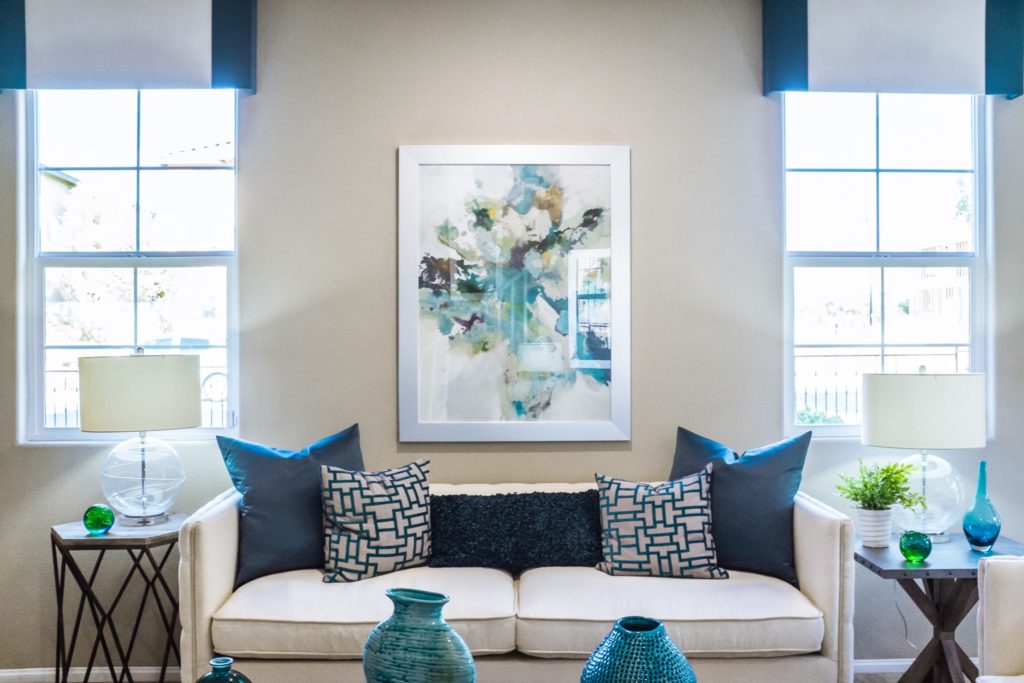 Portland upholstery white sofa in living room with blue throw pillows